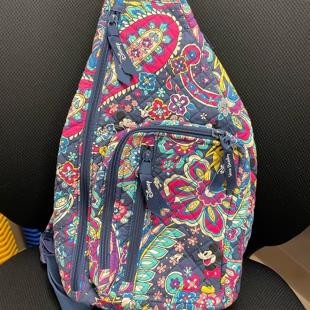 Vera Bradley Disney Paisley Sensational Six Sling Backpack with prominent Mickey